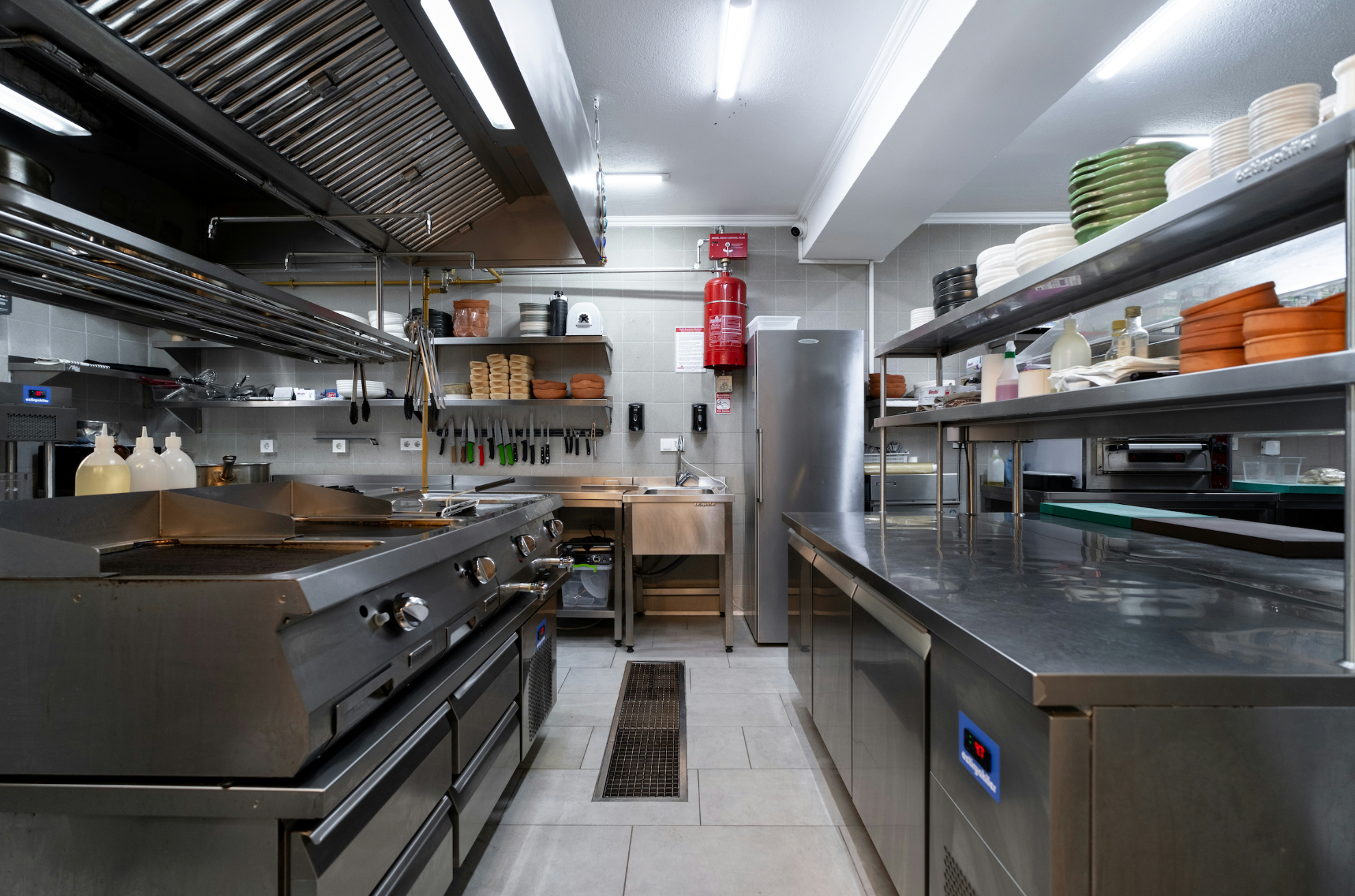 Commercial kitchen with stainless steel appliances and equipment.