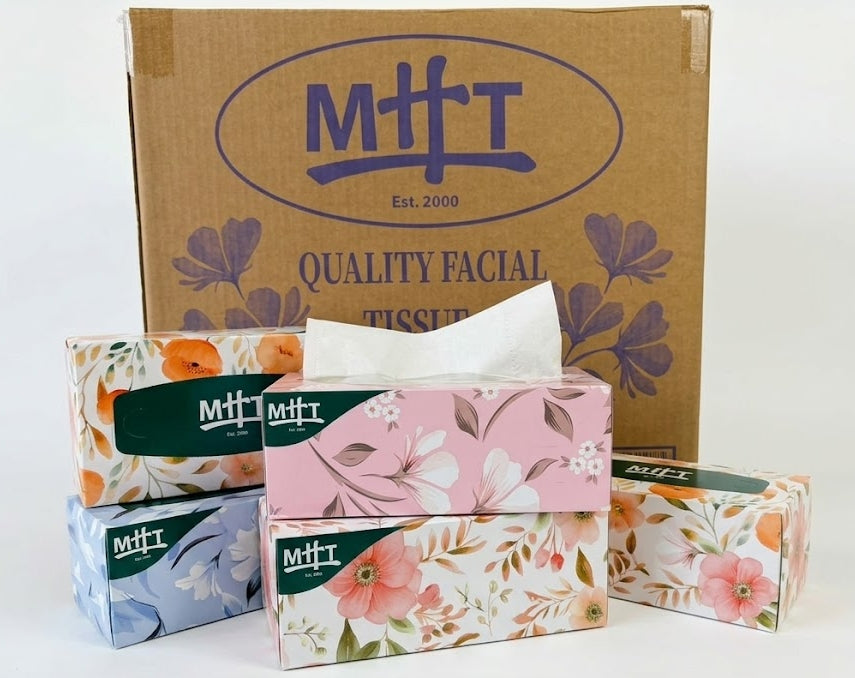 Floral-patterned facial tissue boxes with a cardboard box in the background, featuring the brand 'MHT'.