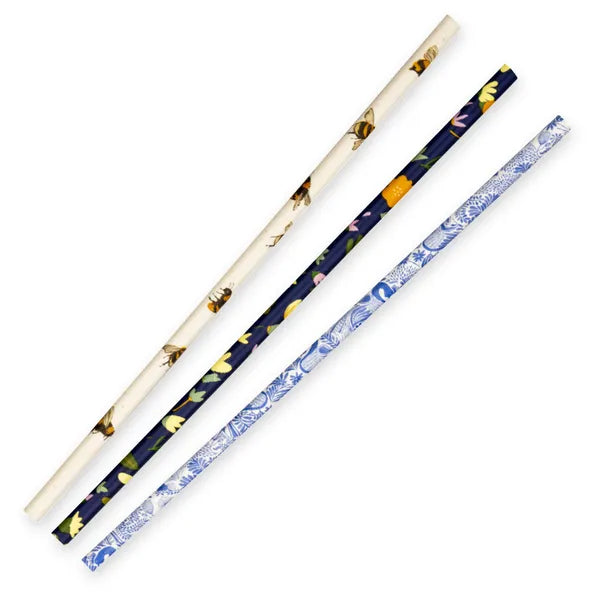 Three floral-patterned straws on a white background